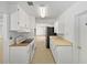 Functional kitchen with white cabinets, modern appliances, and ample counter space at 1209 Stevens Ave, Orlando, FL 32806