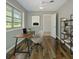 Well-lit office space featuring hardwood floors, a modern desk, and shelving for organization at 1209 Stevens Ave, Orlando, FL 32806