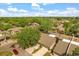 Expansive aerial view of a residential community with tree-lined streets and well-maintained townhomes under a partly cloudy sky at 121 Teriwood St, Fern Park, FL 32730