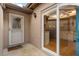 Inviting entryway with sliding glass door, showing a glimpse into the well-lit kitchen and a white paneled front door at 121 Teriwood St, Fern Park, FL 32730