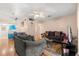 Comfortable living room with hardwood floors, ceiling fan and access to the kitchen and dining areas at 121 Teriwood St, Fern Park, FL 32730