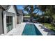 Scenic backyard featuring a sleek pool, patio, sun loungers, and lush landscaping for outdoor enjoyment at 1220 Delaney Park Dr, Orlando, FL 32806
