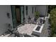 Aerial view of a backyard patio with pavers, a modern fire pit, chairs, privacy fence and landscaping at 1220 Delaney Park Dr, Orlando, FL 32806
