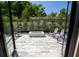 Outdoor patio with pavers and a modern fire pit, surrounded by chairs, greenery and bordered by privacy fencing at 1220 Delaney Park Dr, Orlando, FL 32806