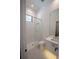 A modern bathroom features a glass shower, stylish gold hardware, and geometric floor tiles at 1220 Delaney Park Dr, Orlando, FL 32806