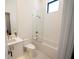 Well-lit bathroom featuring stylish patterned flooring, a combined tub and shower and luxurious gold accents at 1220 Delaney Park Dr, Orlando, FL 32806