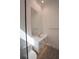 Bathroom featuring a walk-in shower, floating vanity, a stylish mirror, and unique floor tiles at 1220 Delaney Park Dr, Orlando, FL 32806