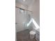 Bathroom with a sleek glass shower door, contrasting honeycomb tile flooring, and tiled walls at 1220 Delaney Park Dr, Orlando, FL 32806