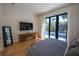 Bright bedroom with hardwood floors, a console table and flat screen TV, and pool view at 1220 Delaney Park Dr, Orlando, FL 32806