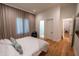 Spacious bedroom with light walls, a comfortable bed, wood floors, and access to a connected bathroom at 1220 Delaney Park Dr, Orlando, FL 32806