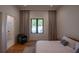Bright bedroom showcasing hardwood floors, with a view into an en-suite bathroom and seating area at 1220 Delaney Park Dr, Orlando, FL 32806