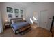 Bright primary bedroom featuring neutral colors, modern fixtures and hardwood floors at 1220 Delaney Park Dr, Orlando, FL 32806