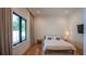 Sunlit bedroom with hardwood floors, black trimmed windows and a minimalist design, promoting a calming atmosphere at 1220 Delaney Park Dr, Orlando, FL 32806