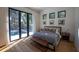 Primary bedroom with hardwood floors, neutral colors and view of the pool at 1220 Delaney Park Dr, Orlando, FL 32806