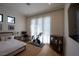 Bright bedroom features a home gym, neutral decor, hardwood floors, and large windows at 1220 Delaney Park Dr, Orlando, FL 32806