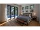This primary bedroom boasts hardwood floors, neutral colors and a view of the pool at 1220 Delaney Park Dr, Orlando, FL 32806