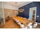 A spacious dining room with modern light fixtures and an extra-long table for hosting at 1220 Delaney Park Dr, Orlando, FL 32806