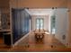 Elegant dining room with a long wood table, unique light fixtures, and glass sliding doors at 1220 Delaney Park Dr, Orlando, FL 32806