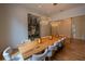 Well-lit dining room with a large wooden table, modern lighting, and a stylish wine storage area at 1220 Delaney Park Dr, Orlando, FL 32806