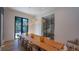 A spacious dining room features a long wooden table, modern lighting, and a glass-enclosed wine rack at 1220 Delaney Park Dr, Orlando, FL 32806
