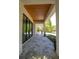 Spacious covered entryway featuring modern brick columns, stone floors, and a wood plank ceiling at 1220 Delaney Park Dr, Orlando, FL 32806