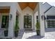 Inviting entrance with a striking front door, modern lighting, and decorative landscaping at 1220 Delaney Park Dr, Orlando, FL 32806