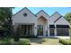 Stunning home showcasing a modern design with a white brick facade and well-manicured lawn at 1220 Delaney Park Dr, Orlando, FL 32806