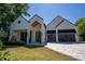 Eye-catching modern home featuring a white exterior, glass garage door, and stylish front yard at 1220 Delaney Park Dr, Orlando, FL 32806