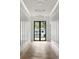Elegant hallway featuring herringbone wood flooring, wainscotting, and stylish modern lighting at 1220 Delaney Park Dr, Orlando, FL 32806
