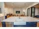 Bright open kitchen with island seating with views into living room at 1220 Delaney Park Dr, Orlando, FL 32806