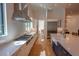 Gourmet kitchen with modern stainless steel range and hood and farmhouse style sink at 1220 Delaney Park Dr, Orlando, FL 32806