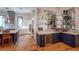 Modern kitchen with stainless steel appliances, island seating, and wet bar nearby at 1220 Delaney Park Dr, Orlando, FL 32806