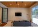 Bright living room with a sleek TV, comfortable seating, stylish decor, and backyard view at 1220 Delaney Park Dr, Orlando, FL 32806