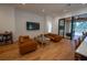 Bright living room with white brick accent wall and view to outdoor pool area at 1220 Delaney Park Dr, Orlando, FL 32806