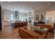 Open-concept living room with island seating, wet bar, and light hardwood flooring at 1220 Delaney Park Dr, Orlando, FL 32806