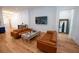 Comfortable living area featuring sleek leather sofas, a modern coffee table, and hardwood floors at 1220 Delaney Park Dr, Orlando, FL 32806