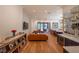 Expansive living room featuring bar area, kitchen view, and hardwood floors at 1220 Delaney Park Dr, Orlando, FL 32806