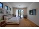 Bright and spacious main bedroom features hardwood floors, large windows, a king size bed and TV at 1220 Delaney Park Dr, Orlando, FL 32806