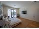 Spacious main bedroom features hardwood floors, large windows, a king size bed and TV at 1220 Delaney Park Dr, Orlando, FL 32806