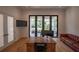 Elegant office with large windows offering a view, a stylish leather couch and wood floors at 1220 Delaney Park Dr, Orlando, FL 32806