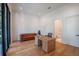 Spacious office featuring a leather couch, wooden desk, hardwood floors, and large windows at 1220 Delaney Park Dr, Orlando, FL 32806