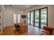 Bright home office with large windows, hardwood flooring, and a rustic wooden desk at 1220 Delaney Park Dr, Orlando, FL 32806