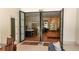 View of the kitchen and living areas through folding glass doors, creating a seamless indoor-outdoor flow at 1220 Delaney Park Dr, Orlando, FL 32806