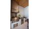 Stylish outdoor kitchen with stainless steel grill, hood, sink, and mini-fridge at 1220 Delaney Park Dr, Orlando, FL 32806