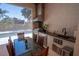 Beautiful outdoor kitchen with stainless steel appliances, grill, sink, and dining area overlooking the pool at 1220 Delaney Park Dr, Orlando, FL 32806