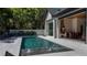 Beautiful pool area with lounge chairs and a covered outdoor kitchen, perfect for entertaining at 1220 Delaney Park Dr, Orlando, FL 32806