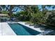 Stunning pool area with lounge chairs, an outdoor dining table, and mature trees offering shade at 1220 Delaney Park Dr, Orlando, FL 32806