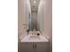 Modern powder room with a stylish vanity, elegant faucet, and decorative mirror at 1220 Delaney Park Dr, Orlando, FL 32806
