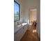 Hallway sink featuring marble countertop, gold hardware, and a sunlit window at 1220 Delaney Park Dr, Orlando, FL 32806