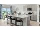 Open kitchen and dining area featuring a central island with bar stools and modern appliances at 1222 Alstonia Ln, Mount Dora, FL 32757